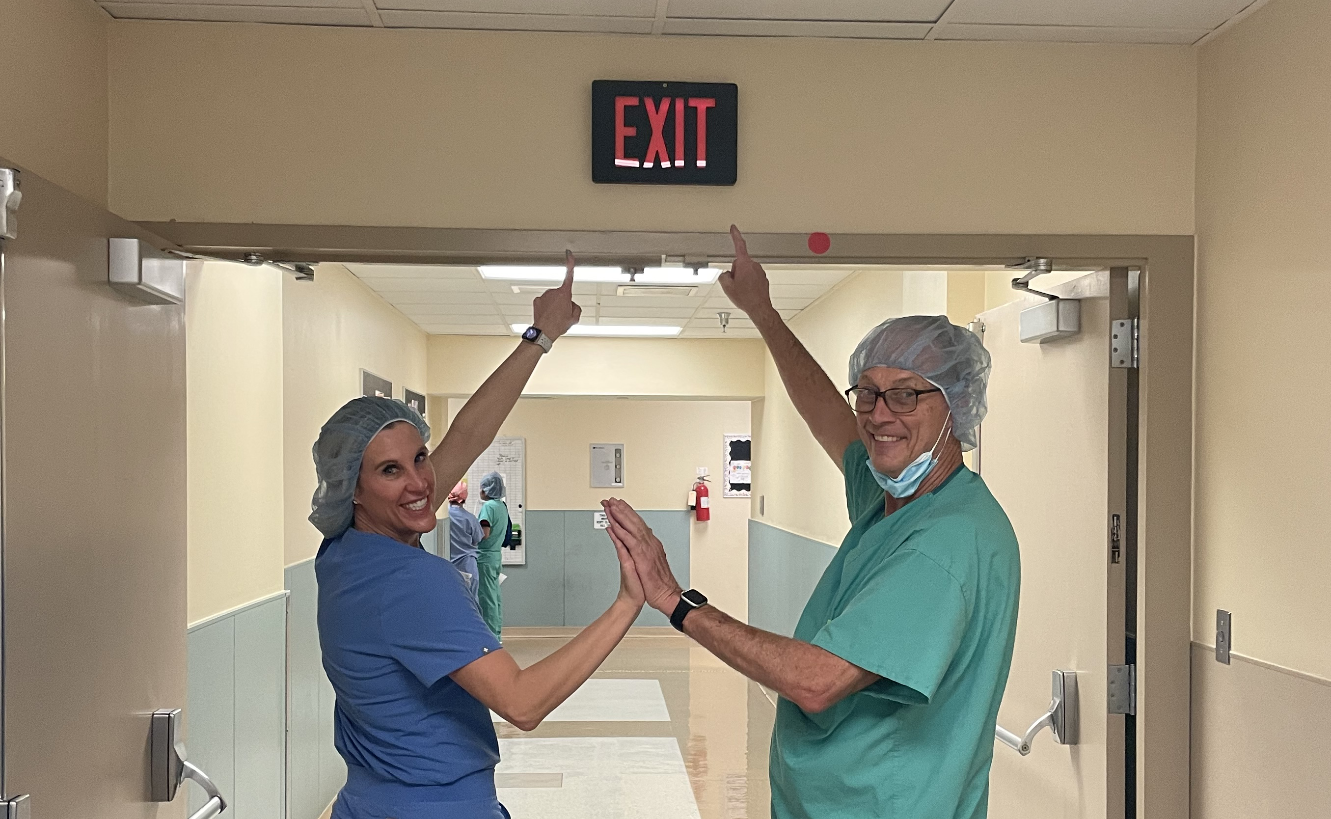 Mike and his daughter, Jennifer, walk hand-in-hand out of the surgical room for the last time before his retirement. Photo courtesy of the Owen family